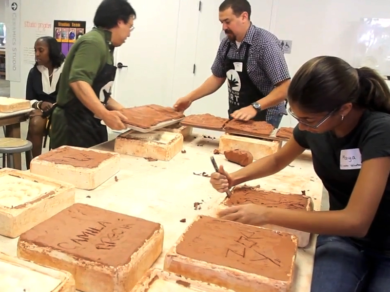 Carlos Ramirez making clay tiles with participants